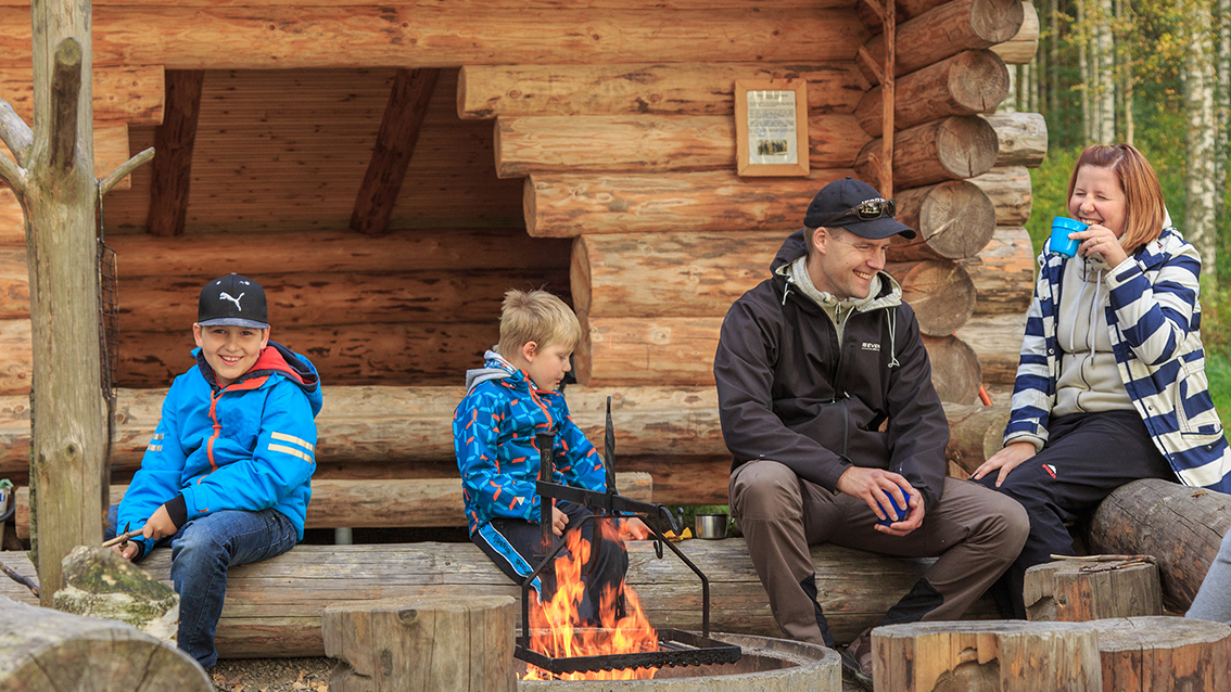 A family at the campfire in autumn.